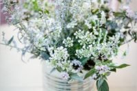 21 a rustic Scandinavian centerpiece of a tin can with wildflowers is great for a spring or summer wedding