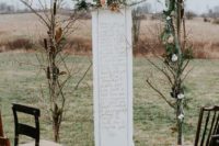 21 a simple boho winter wedding arch of branches, foliage and blooms with a romantic text handwritten