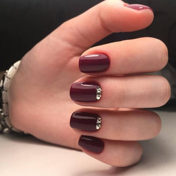 burgundy jeweled nails are a chic idea for both a fall or a winter wedding or if you love jewel tones