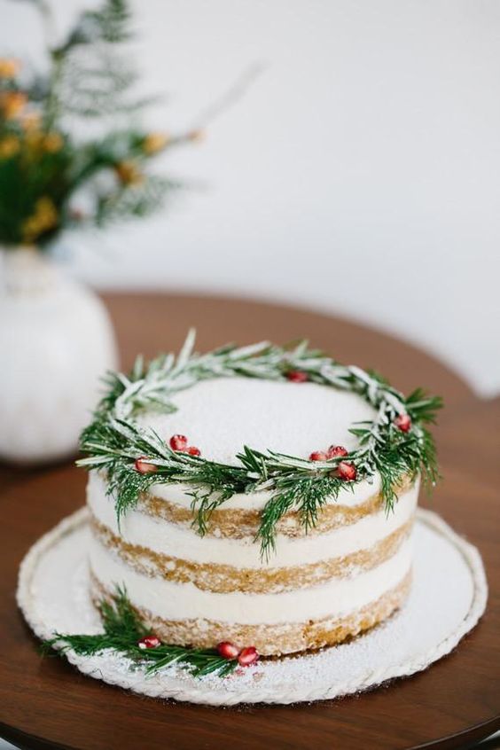 serve several naked wedding cakes like this one and top them with pomegranate seeds and fresh greenery