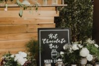 22 a chic hot chocolate bar decorated with florals and greenery and chalkboard signs