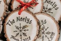 22 cool wood slice ornament with the wedding date and names burnt on them and a red bow