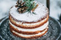 24 a naked Scandinavian winter wedding cake topped with cinnamon sticks, evergreens and a pinecone is a simple and cute idea