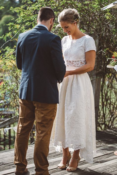 a romantic lace two piece wedding dress with a high low midi skirt and a crop top is ideal for a boho bride