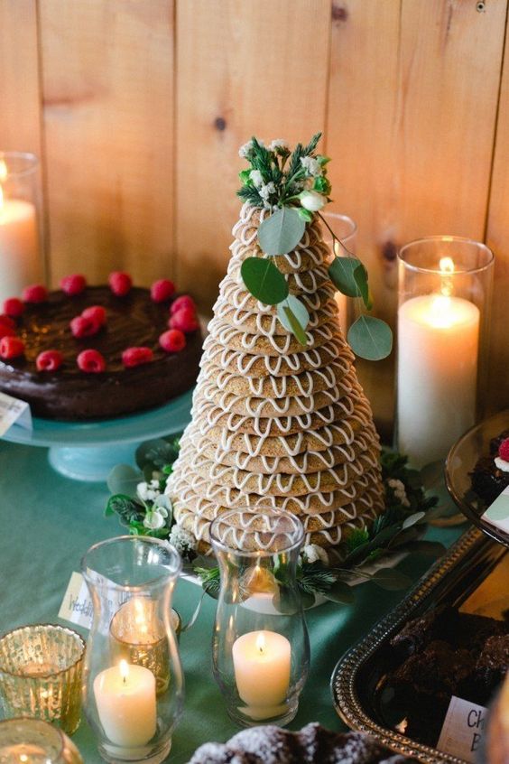 a kransakake, a traditional Norwegian or Icelandic wedding cake, topped with blooms and greenery