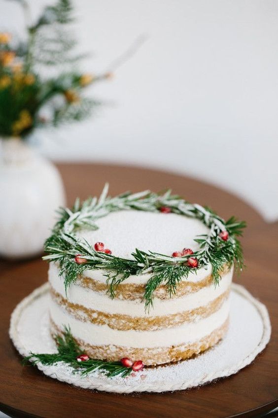 rosemary and pomegranate seeds on this gorgeous cake are a chic way to incorporate traditional holiday colors