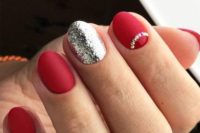 29 matte red nails, a silver glitter accent and a jeweled nail for a chic Christmassy look