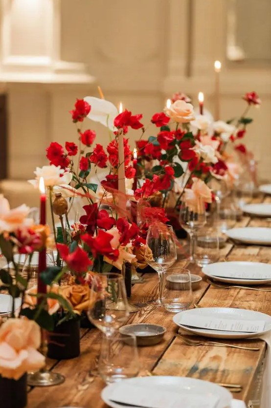 a sophisticated wedding tablescape with red and blush roses and matching candles is a great idea for a winter wedding