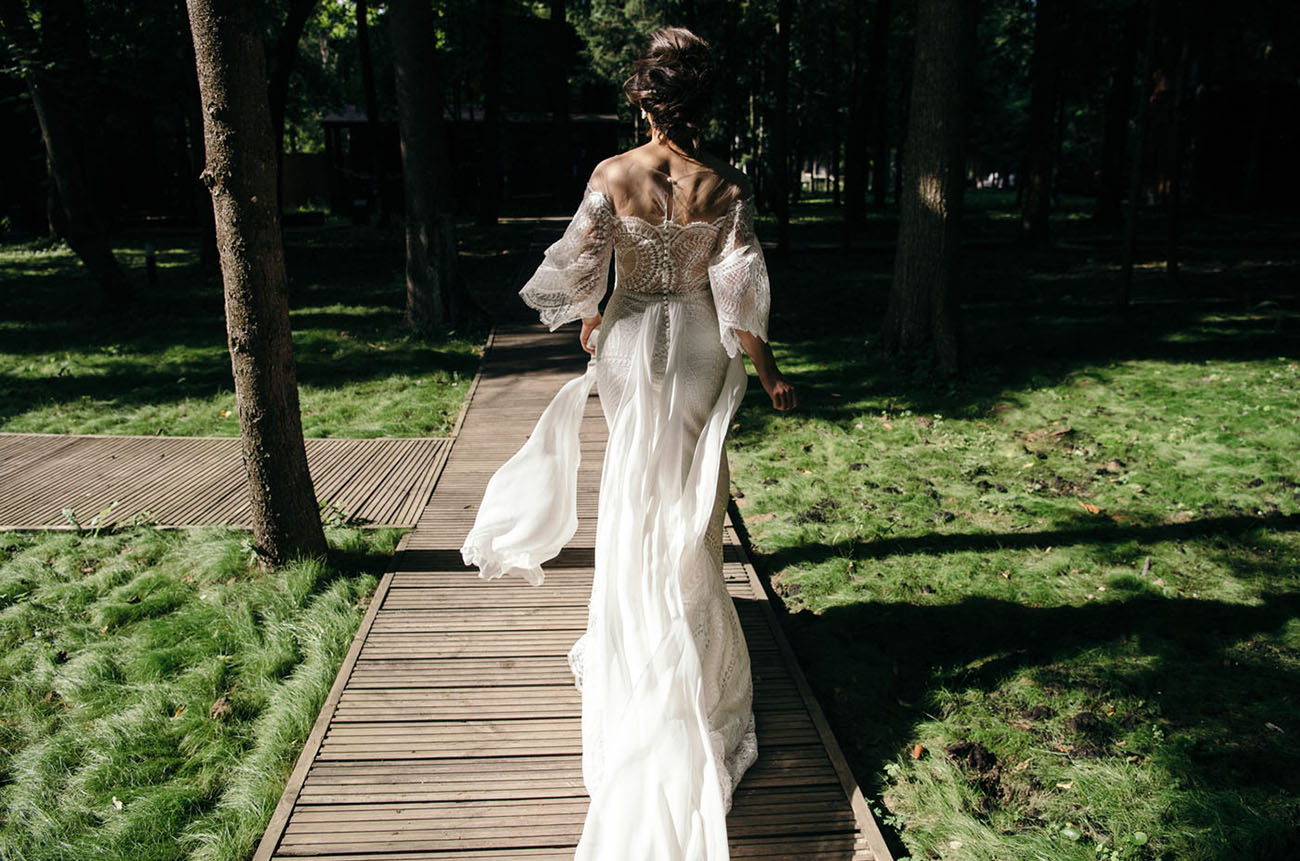 The bride was wearing a fantastic embroidered and embellished fitting wedding dress with a train and an illusion off the shoulder neckline