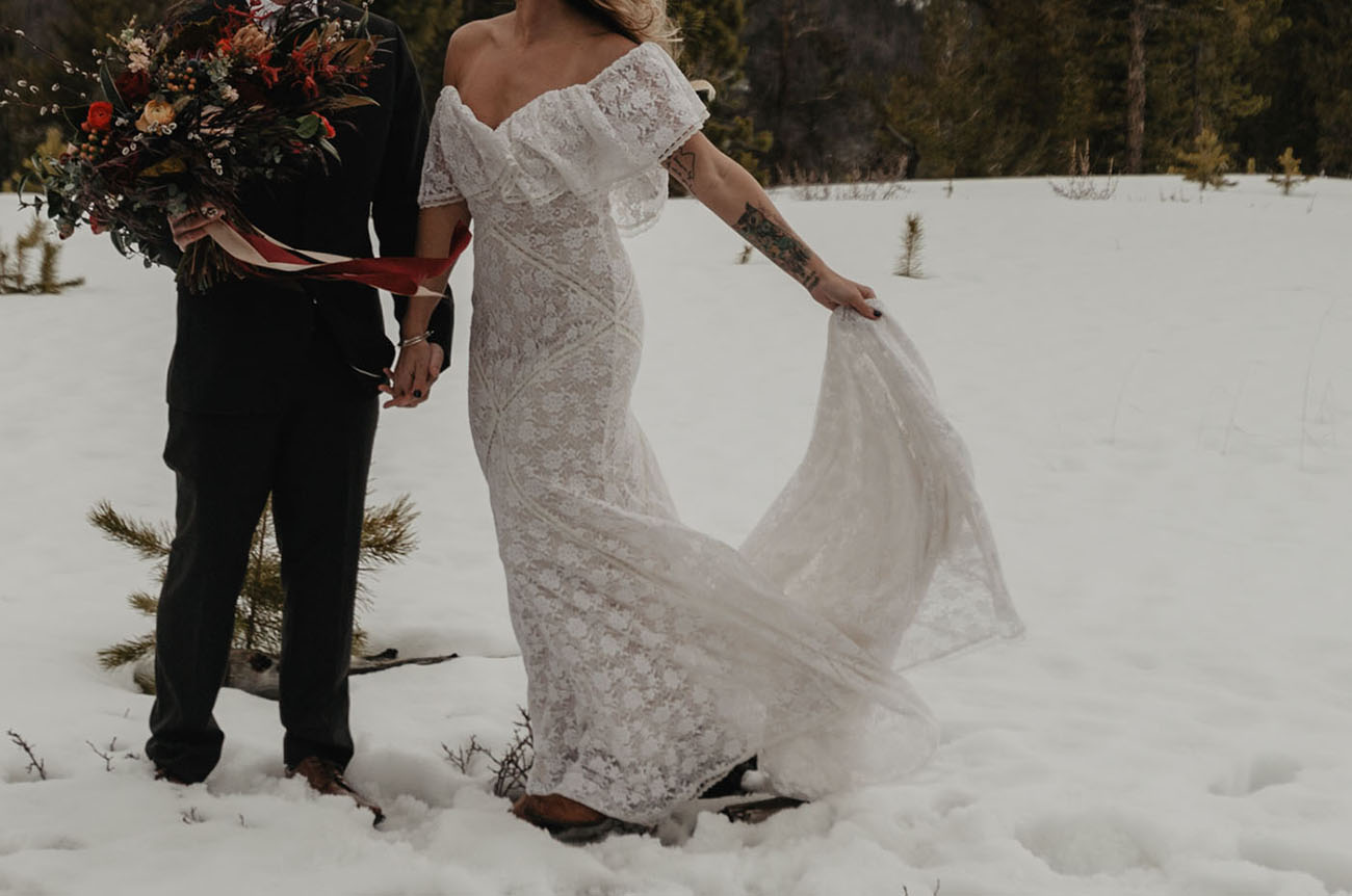The bride was wearing an off the shoulder boho lace wedding dress and boots