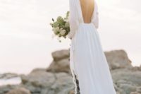 02 an airy and flowy wedding gown with an open back and long sleeves is a cool modern idea