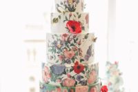 an oversized wedding cake with white and green tiers, with handpainted flowers and sugar blooms is a gorgeous statement