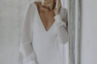 04 a modern and elegant wedding dress with a fitting silhouette, a plunging neckline, long sleeves and tassel earrings
