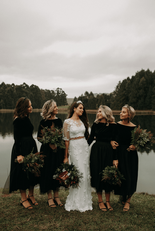 The bridesmaids were wearing black bodysuits and black tulle midi skirts plus black shoes