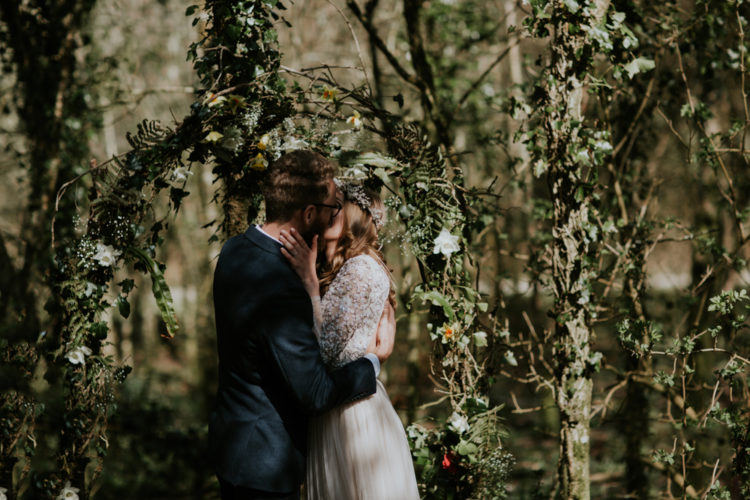 The wedding arch was made of branches, greenery and blooms and was placed in the woodlands