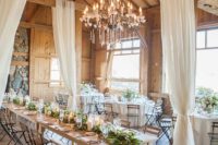 05 a rustic wedding reception space filled with light, greenery and with airy curtains