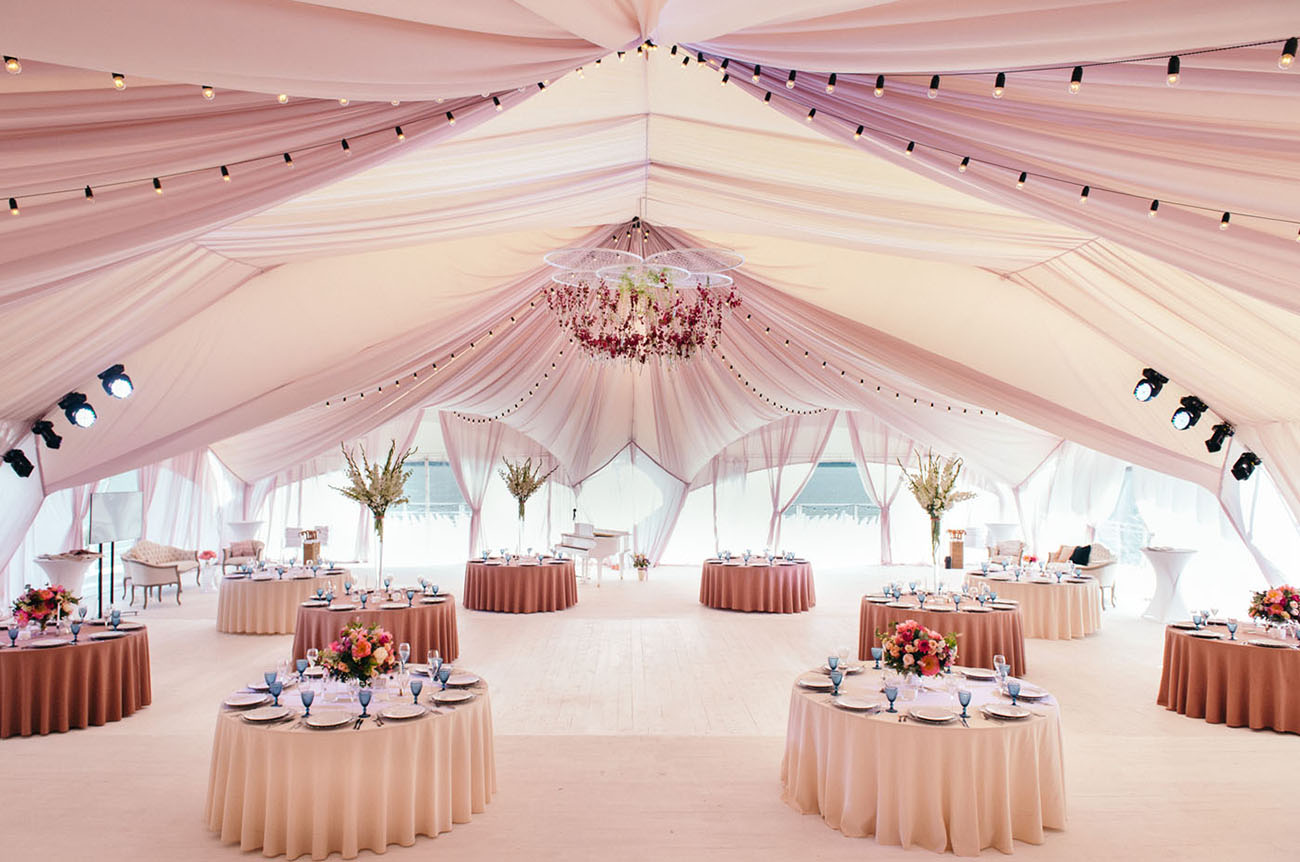 A huge tent by the lake was done in rosy shades to become their reception space