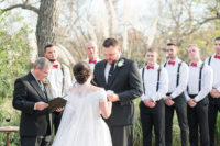 06 The groom was wearing a black suit with a tie and the groomsmen were rocking black pants, suspenders and red bow ties