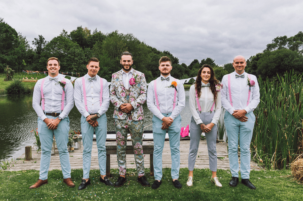 The groomsmen were rocking blue pants, pink suspenders, floral bow ties and white shirts