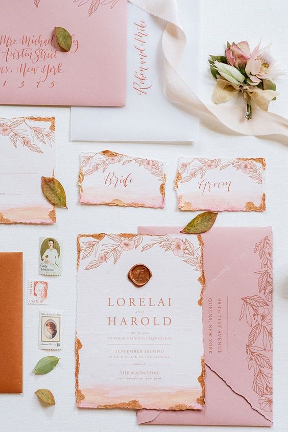 a beautiful and delicate wedding invitation suite done in peahcy pink and with copper leaf touches