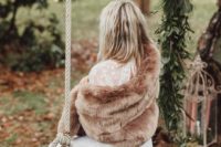 07 a large and comfy camel fur coat is a great idea to cover up for a winter boho bride