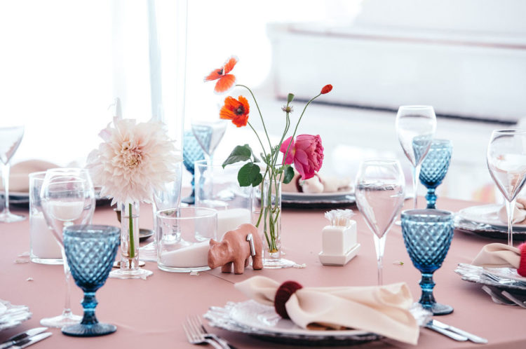 The tablescapes were done with bright blooms, colored glasses and again rhinoes