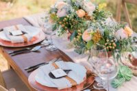 08 a beautiful wedding tablescape with hammered copper chargers and lush floral centerpieces with blush and peachy blooms