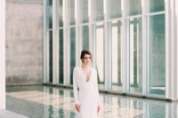 08 a minimalist wedding gown with a plunging neckline, long sleeves, a train for a Nordic bride