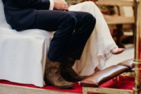 09 The groom was wearing a navy three-piece suit, a white bow tie and brown cowboy boots