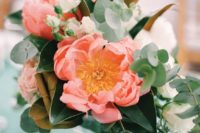 10 a textural wedding centerpiece with foliage and coral blooms is a piece that can be made in a minute by you yourself
