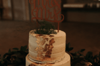 11 The wedding cake was a naked one decorated with gold leaf, herbs and a calligraphy topper