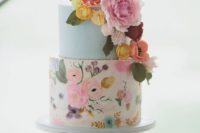 11 a colorful handpainted wedding cake with a light blue tier, a bright floral tier in various shades and sugar flower decor