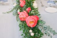 12 a lush wedding table runner of greenery and coral blooms is sure to catch an eye and add to your wedding decor