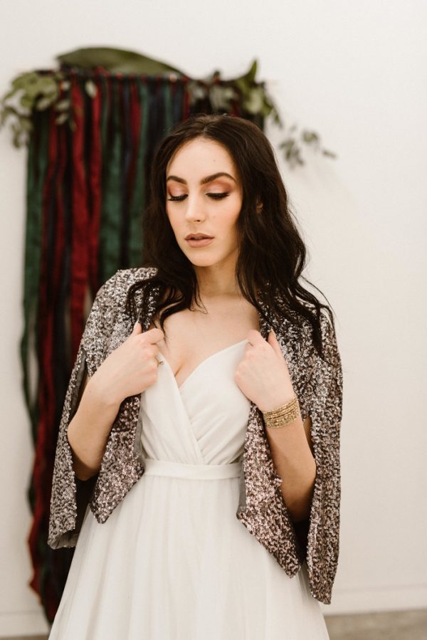 a sequin capelet to shine on your holiday wedding day is a cool sparkly idea with a trendy feel
