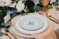 16 peachy napkins, copper glasses and a lush greenery and white bloom table runner plus gold cutlery