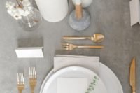 19 a minimalist wedding table setting with a grey tablecloth, gold cutlery and white candles looks ethereal