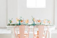 20 copper chairs, a wedding reception table decorated with greenery and peachy blooms for a cool look