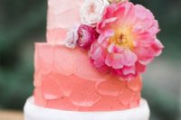 21 a buttercream ombre coral wedding cake with fresh blooms has a killing and very trendy look