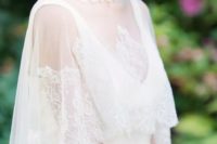 23 a Chantilly lace turtleneck cape over a deep V-neckline minimalist wedding dress adds romance to the look