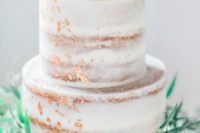 23 a naked wedding cake with peahcy blooms on top and copper leaf decor is an gorgeous and trendy idea