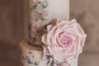 24 a delicate wedding cake with pastel handpainted blooms and very natural looking pastel sugar blooms