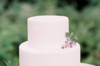 24 a minimalist plain white wedding cake topped with some berries for a modern natural or minimalist wedding