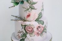 26 an exquisite handpainted wedding cake with rose and some lavender on top looks like a real work of art