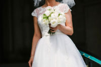 02 a 50s inspired bridal look with a polka dot sleeveless tea-length wedding dress with a sash, statement earrings and a veil