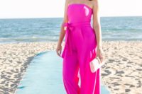 02 a hot pink strapless jumpsuit with a sash, a small clutch and pink earrings for a modern look