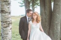 02 a romantic and vintage-inspired empire waist wedding dress with a lace bodice, cap sleeves and a plain flowy skirt