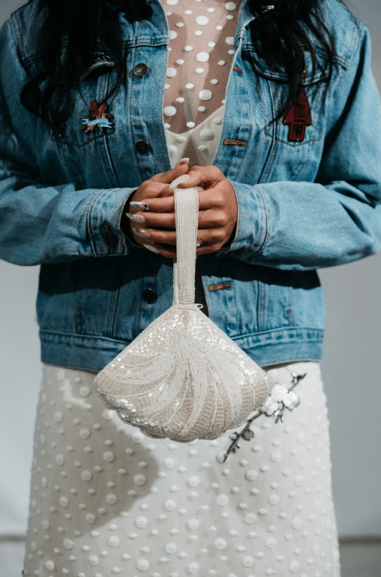 She covered up with an oversized denim jacket and here's her amazing bridal purse - all sparkling and shiny