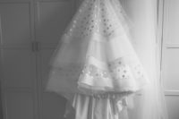 03 a retro-inspired A-line polka dot wedding dress with a train, a large bow sash and a long veil