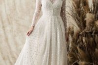 04 a vintage-inspired polka dot wedding dress with an illusion strapless neckline, long sleeves and a lace trim