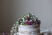05 a vegan rhubarb naked wedding cake topped with white and pink flowers going down